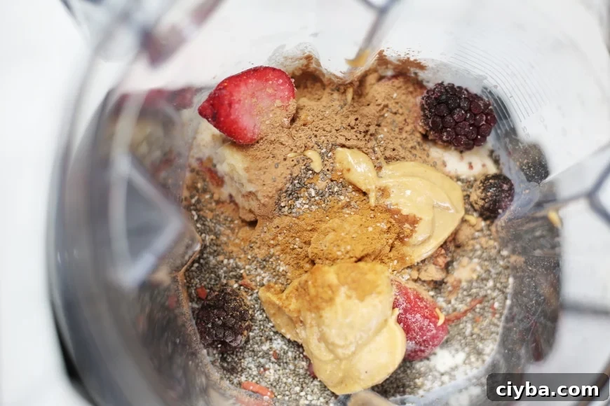 Ingredients for the superfood berry smoothie bowl in the blender container before blending