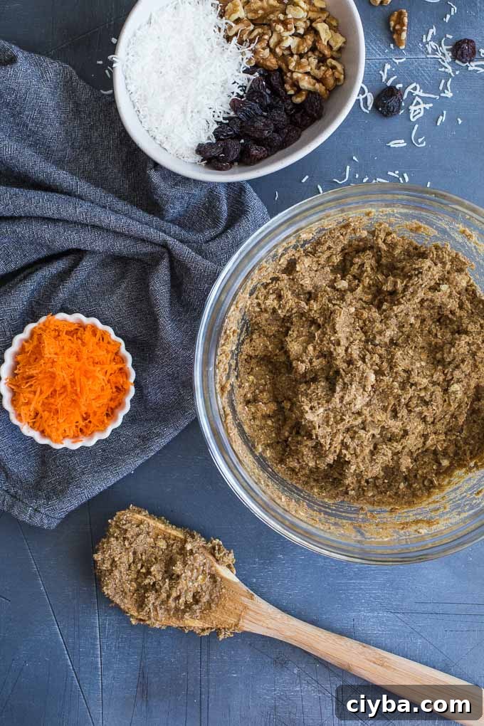 Morning Glory Breakfast Cookies being mixed together in a glass bowl.
