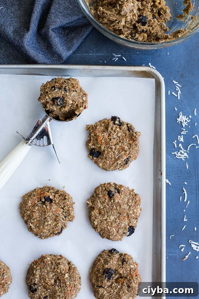 Morning Glory Breakfast Cookies being formed and arranged on a baking sheet.