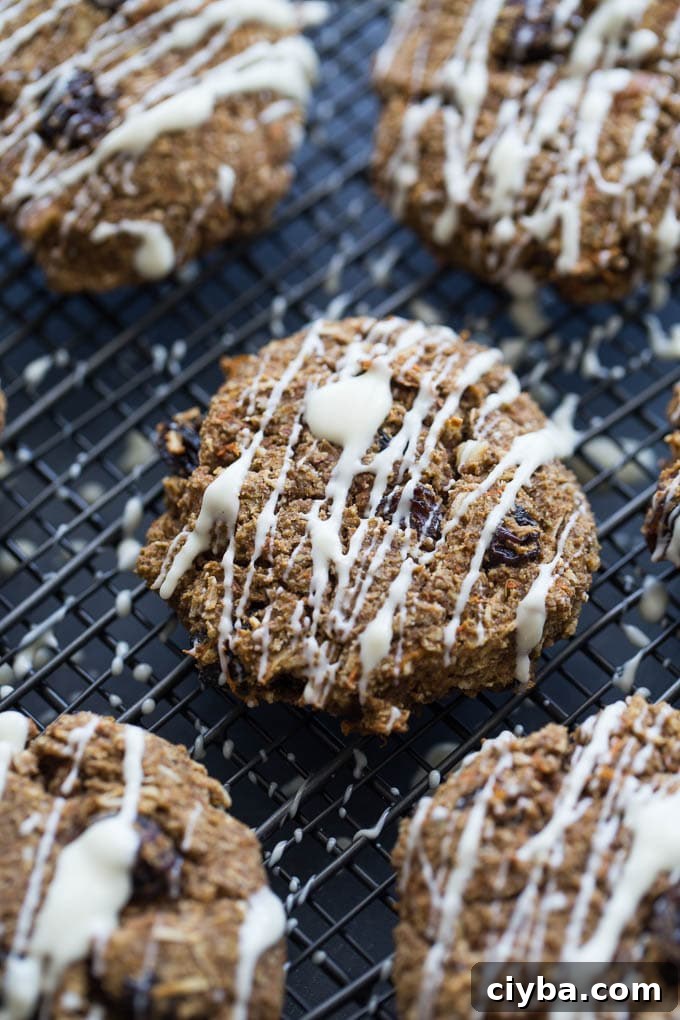 Up-close view of Morning Glory Breakfast Cookies with white chocolate drizzle.