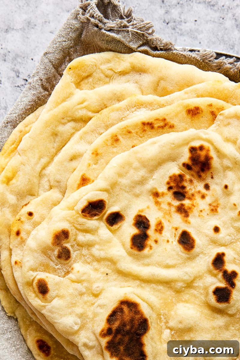 Quick Homemade Flatbread Recipe with Video Tutorial 2 stacked flatbread on grey cloth napkin