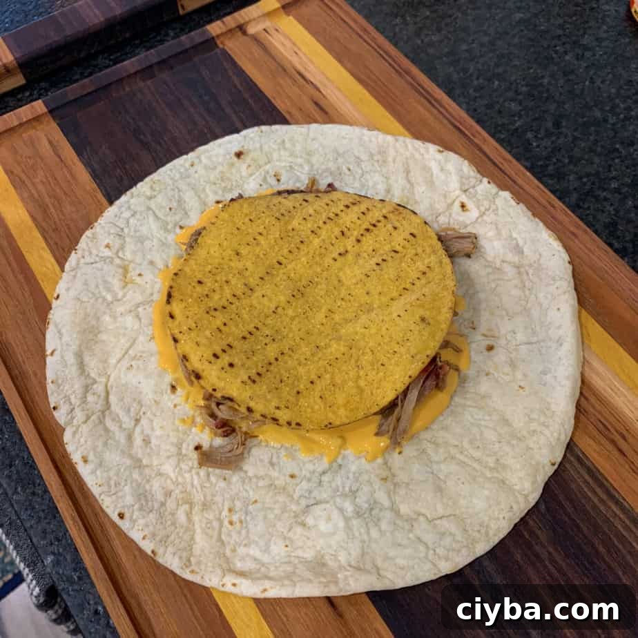 Crispy Pulled Pork Crunchwrap Supreme Recipe 6 tostada shell over toppings and a tortilla