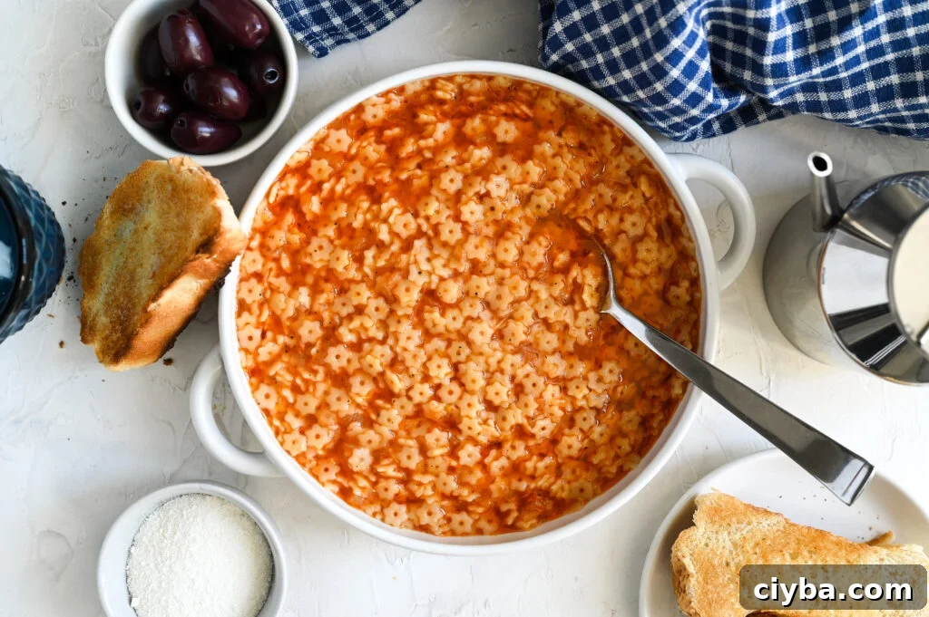 Manestra: A simple Greek soup recipe made with small pasta shapes and a tomato shaped broth.