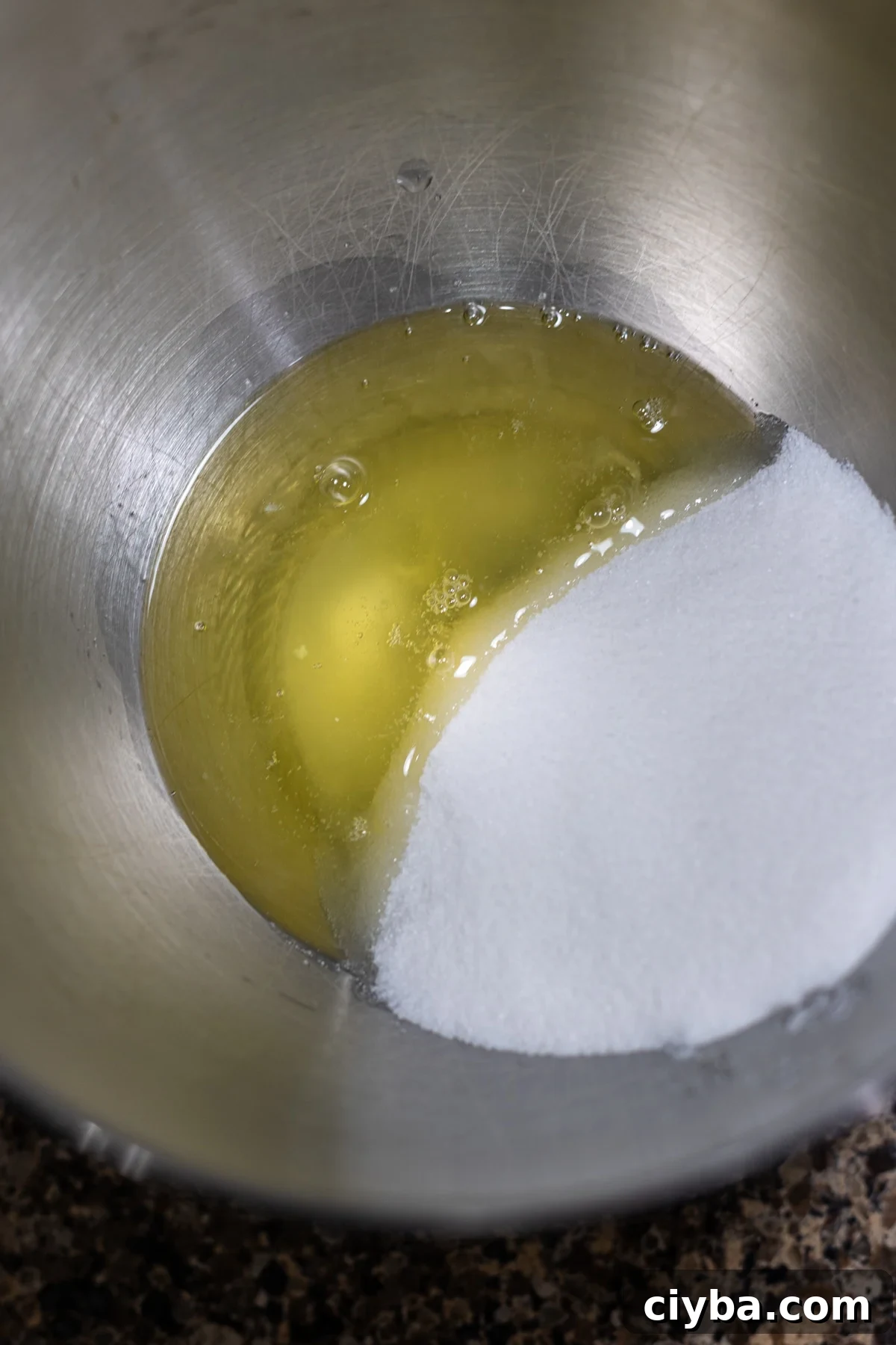 Egg white and sugar in a bowl to make meringue.