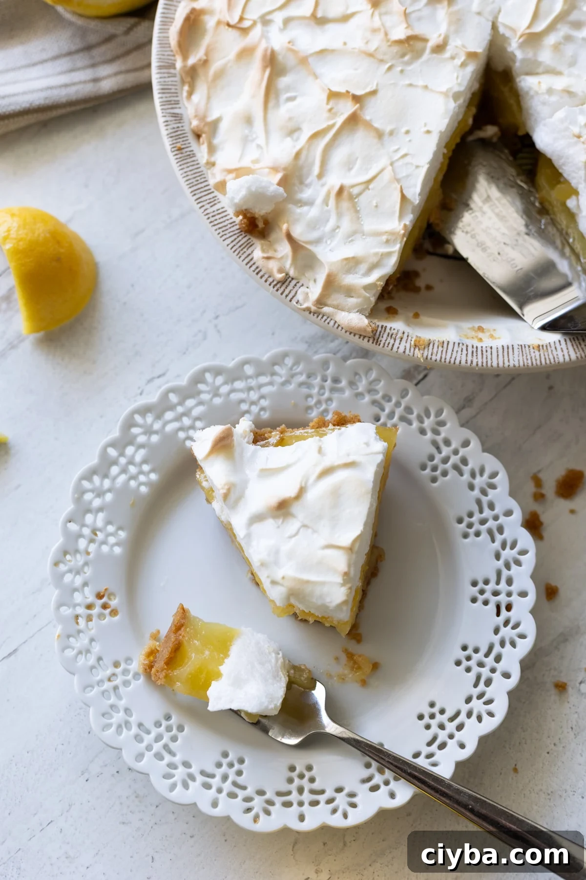 Person eating a piece of lemon meringue pie.