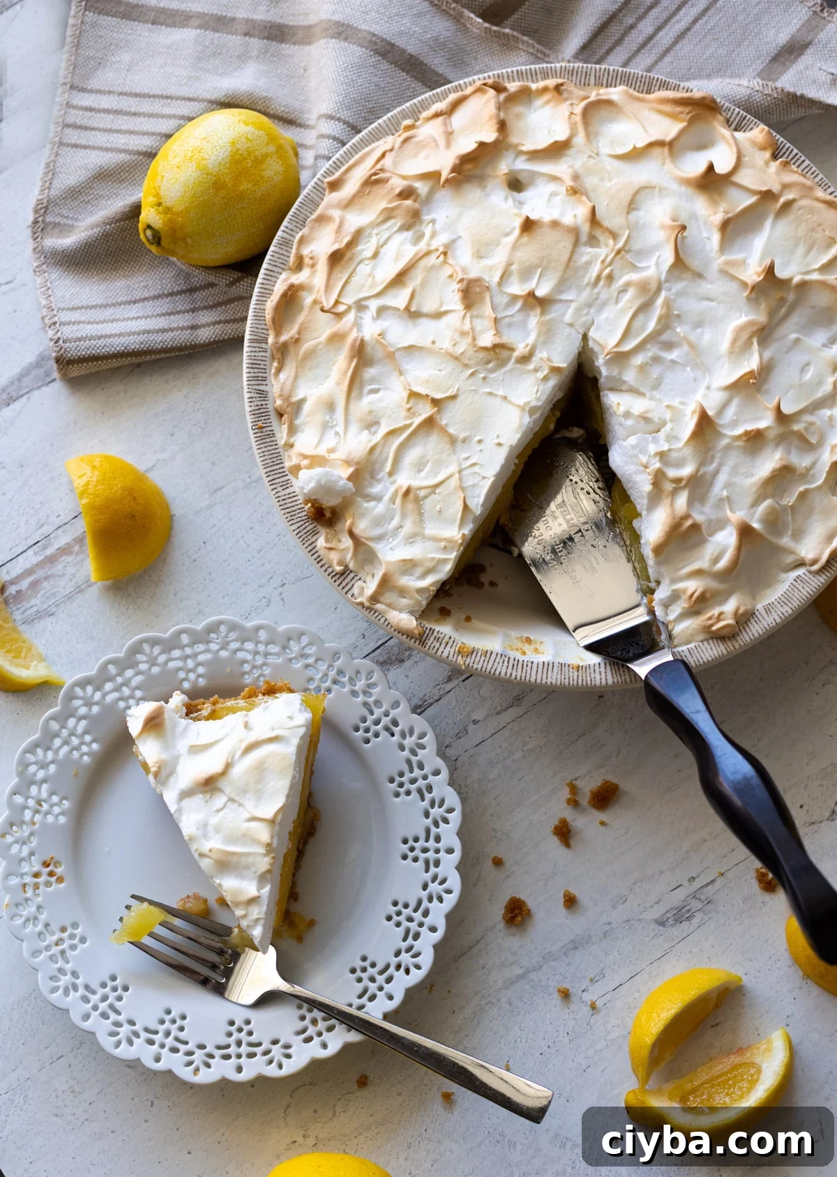 Person slicing and serving a piece of lemon meringue pie.