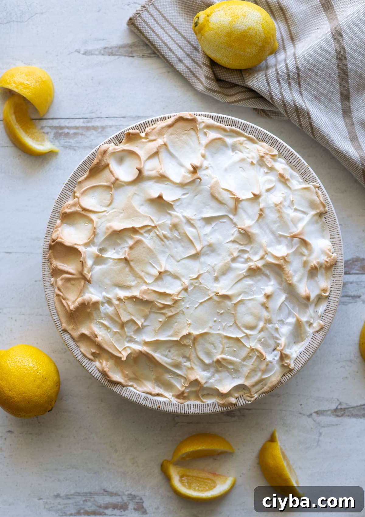 Homemade lemon meringue pie on a table.