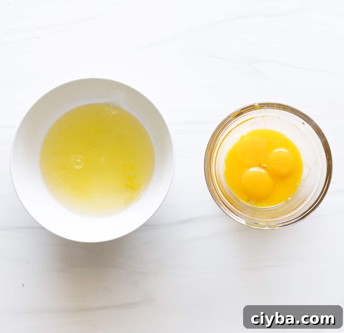 Person separating egg yolks from egg whites.