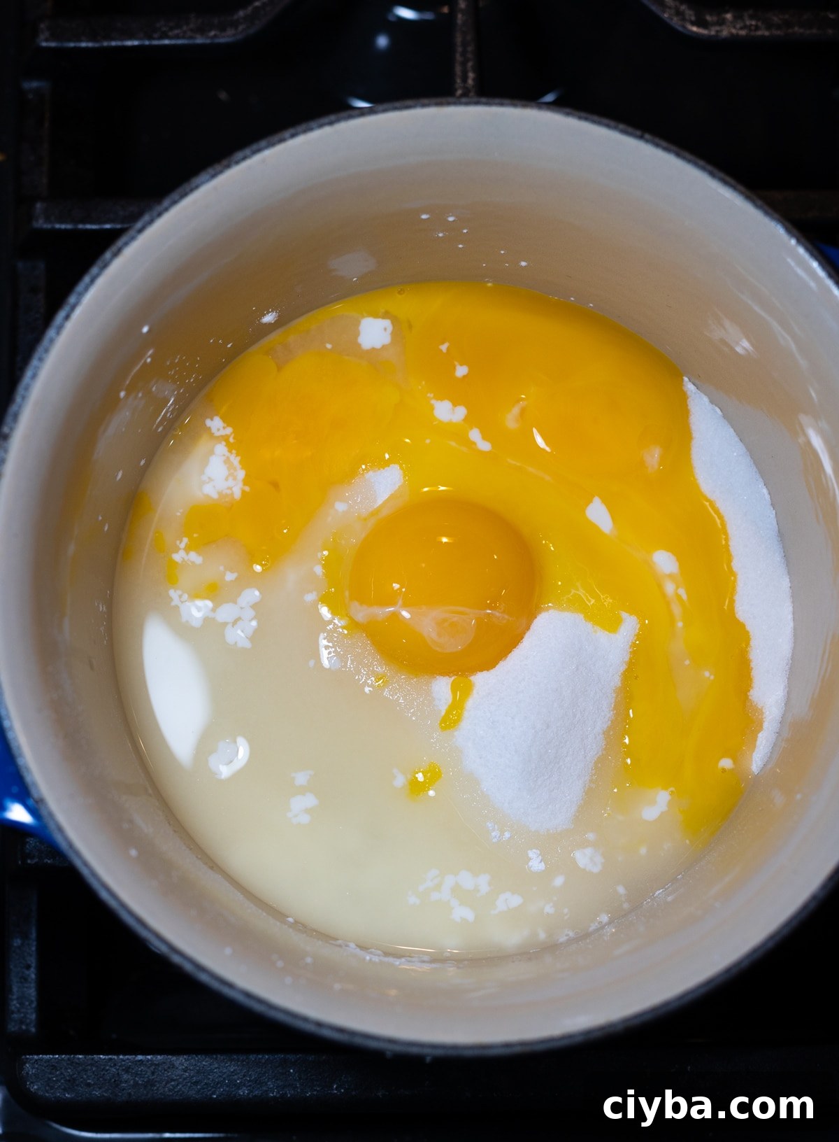 Ingredients added to a saucepan to make lemon meringue pie filling.