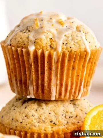 A stack of orange poppy seed muffins with glaze.