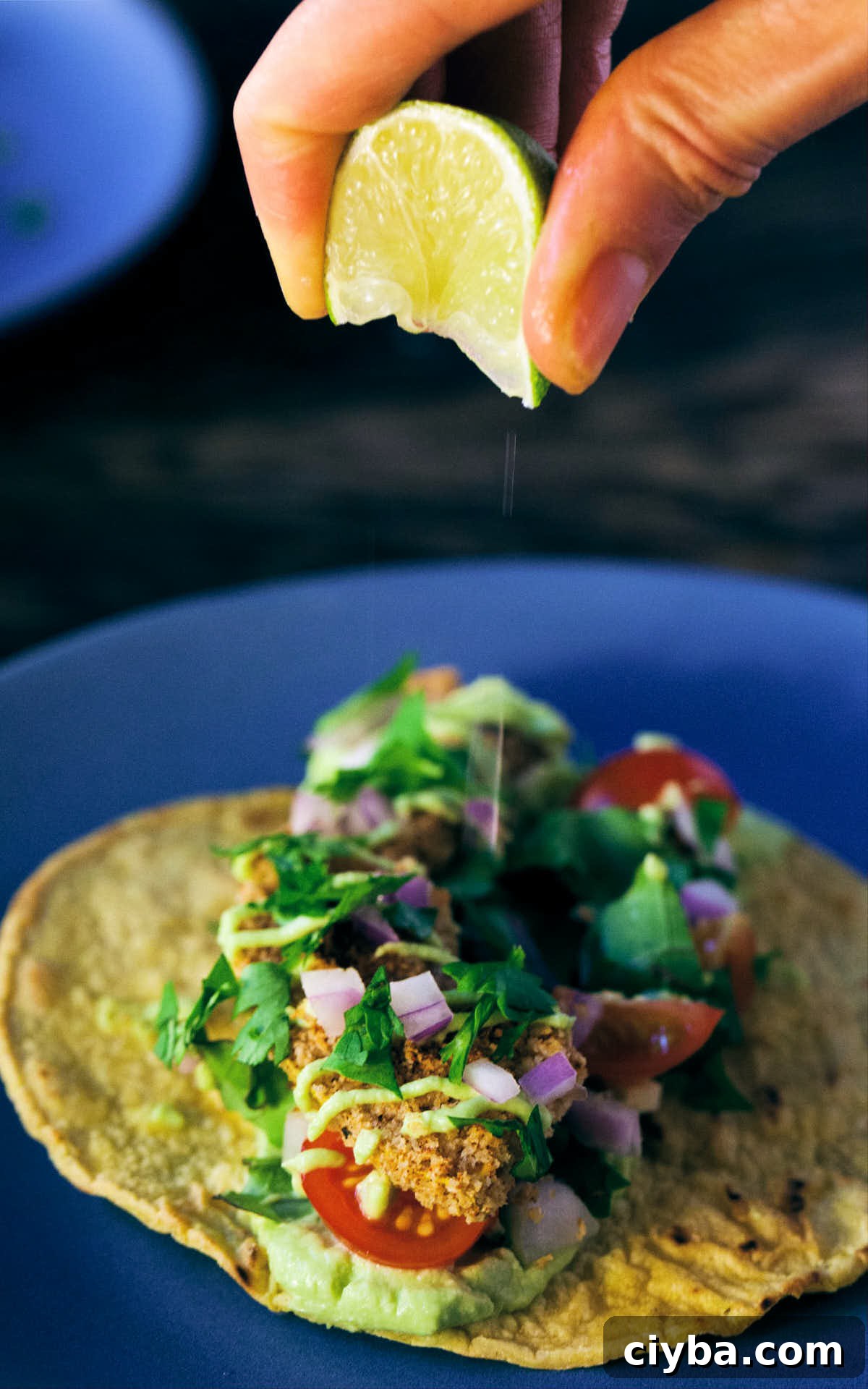 Dressing squash taco with fresh lime juice