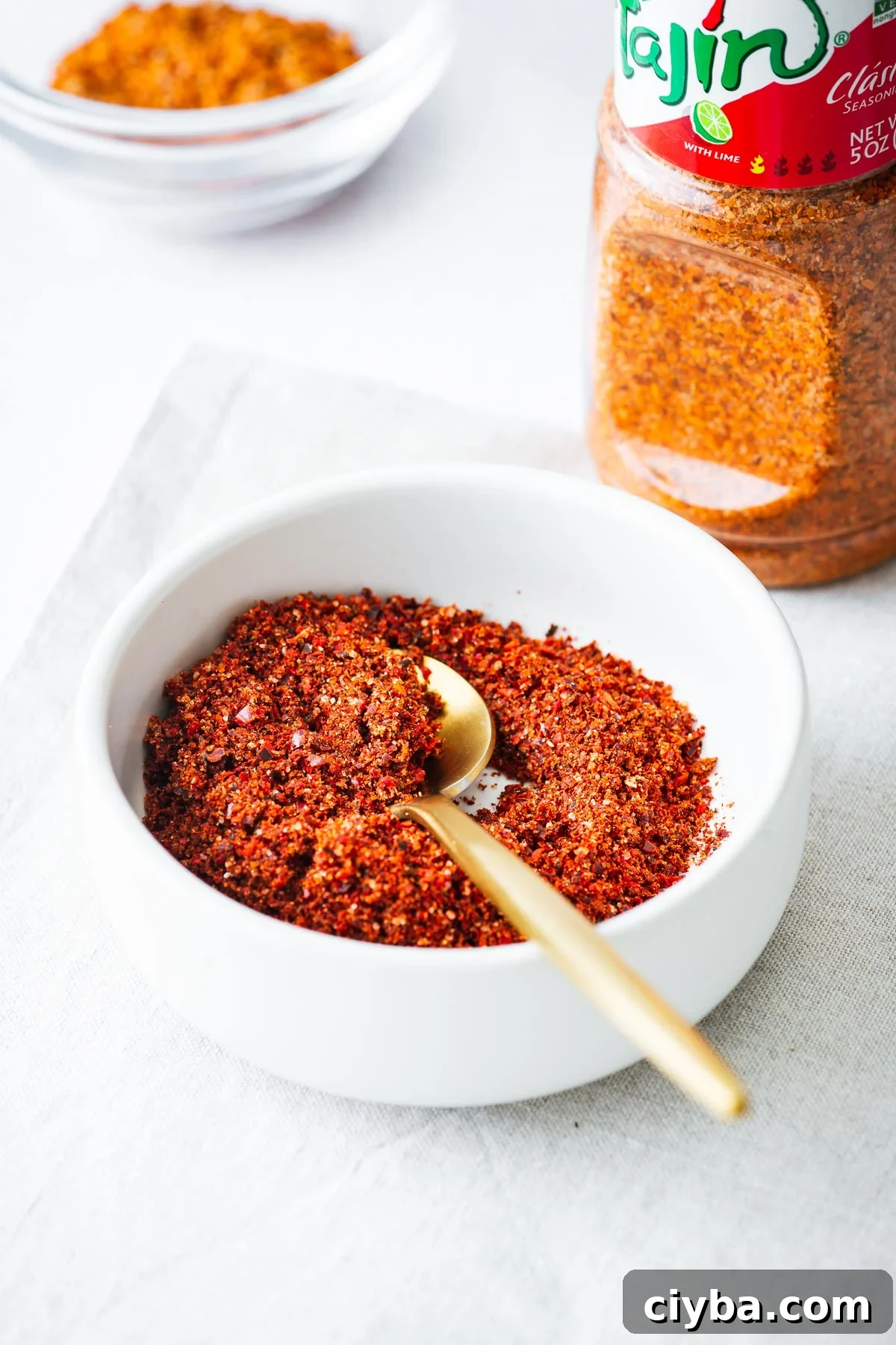 Close-up of a homemade tajin seasoning substitute with a bottle of Tajín Clásico Seasoning in the background.