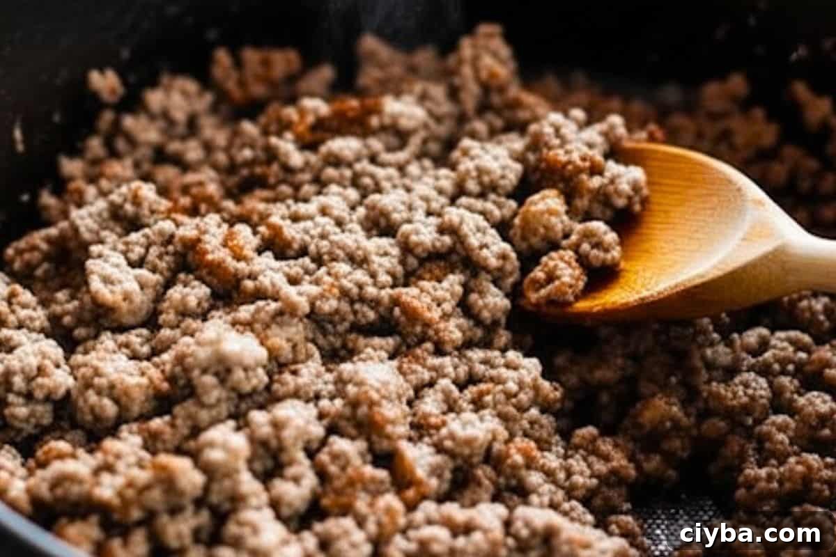 In the same pot, fry the ground beef and sausage and after frying transfer the meat mixture to the slow cooker