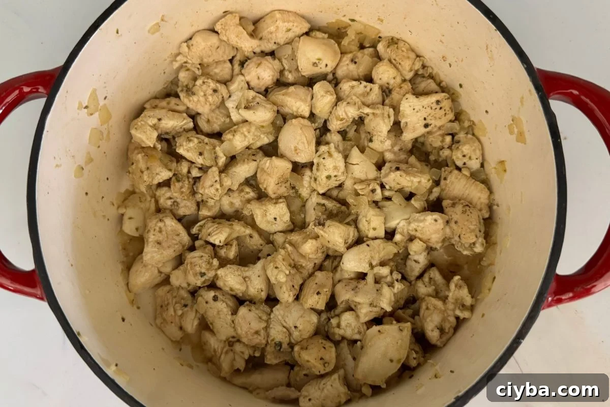 Tomatillo salsa and green chiles in a pan for white chicken chili