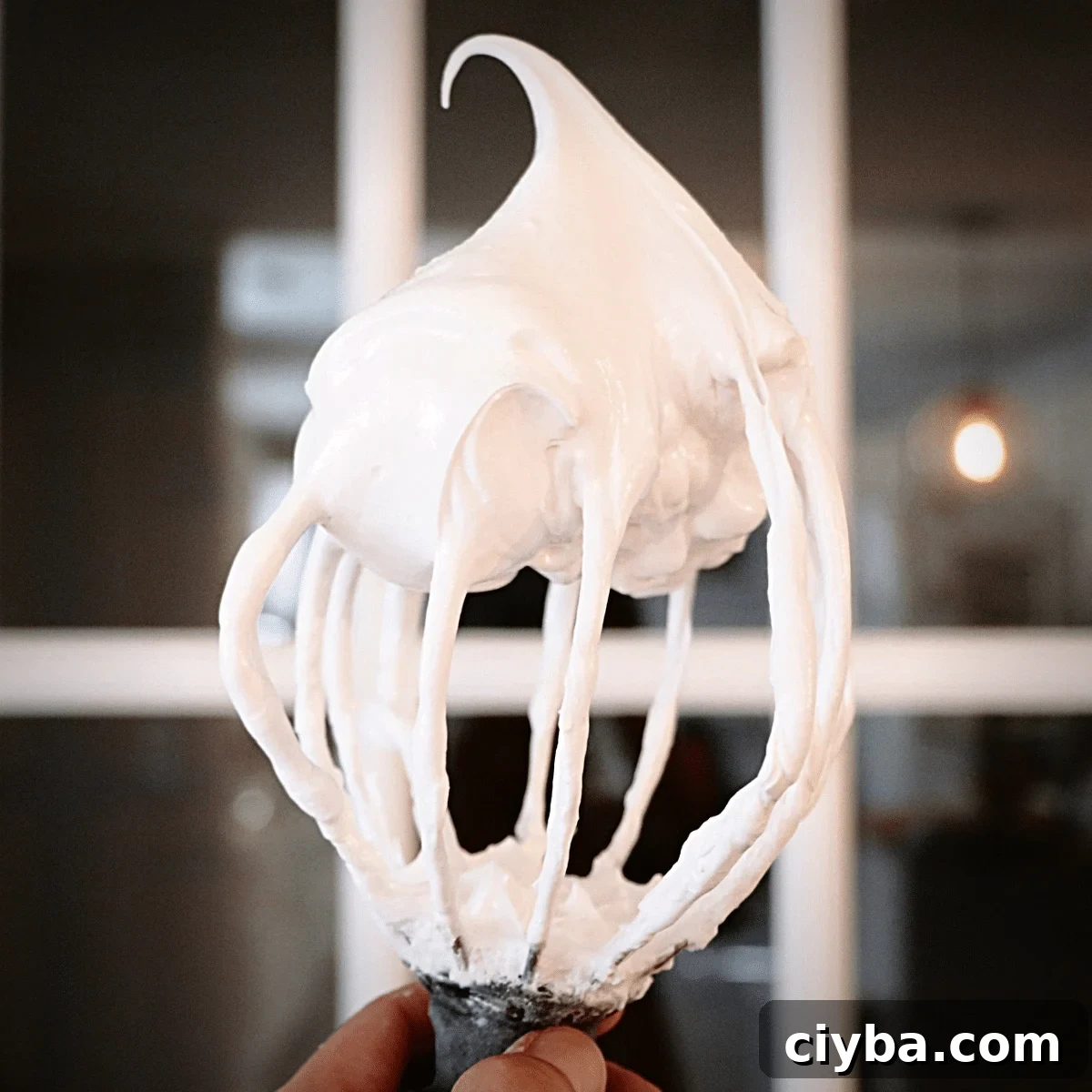 up-close of Italian meringue on a whisk