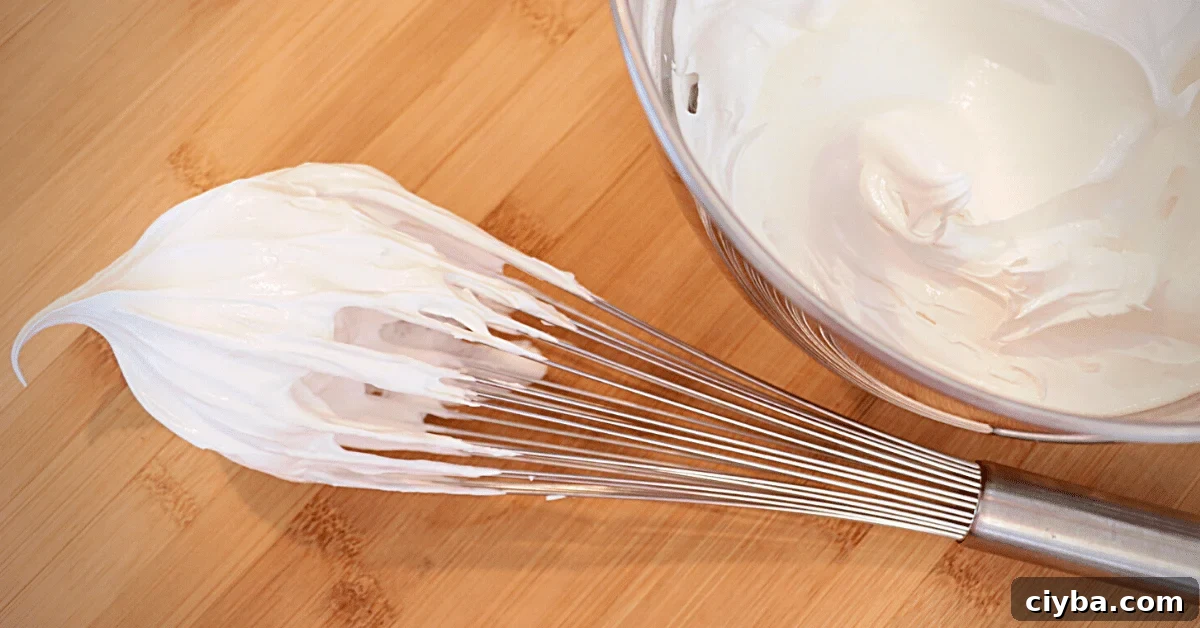 Italian meringue on a whisk and in a bowl
