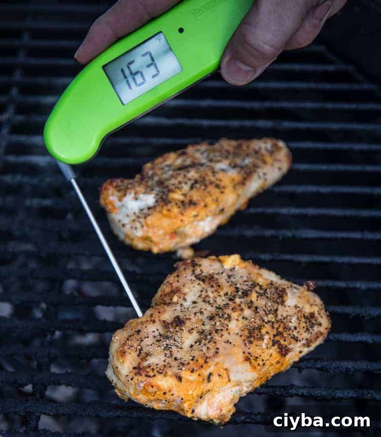 Taking the temperature of stuffed chicken breasts