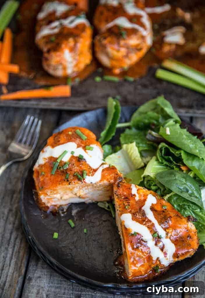 Buffalo Stuffed Chicken Breasts on a plate with salad.