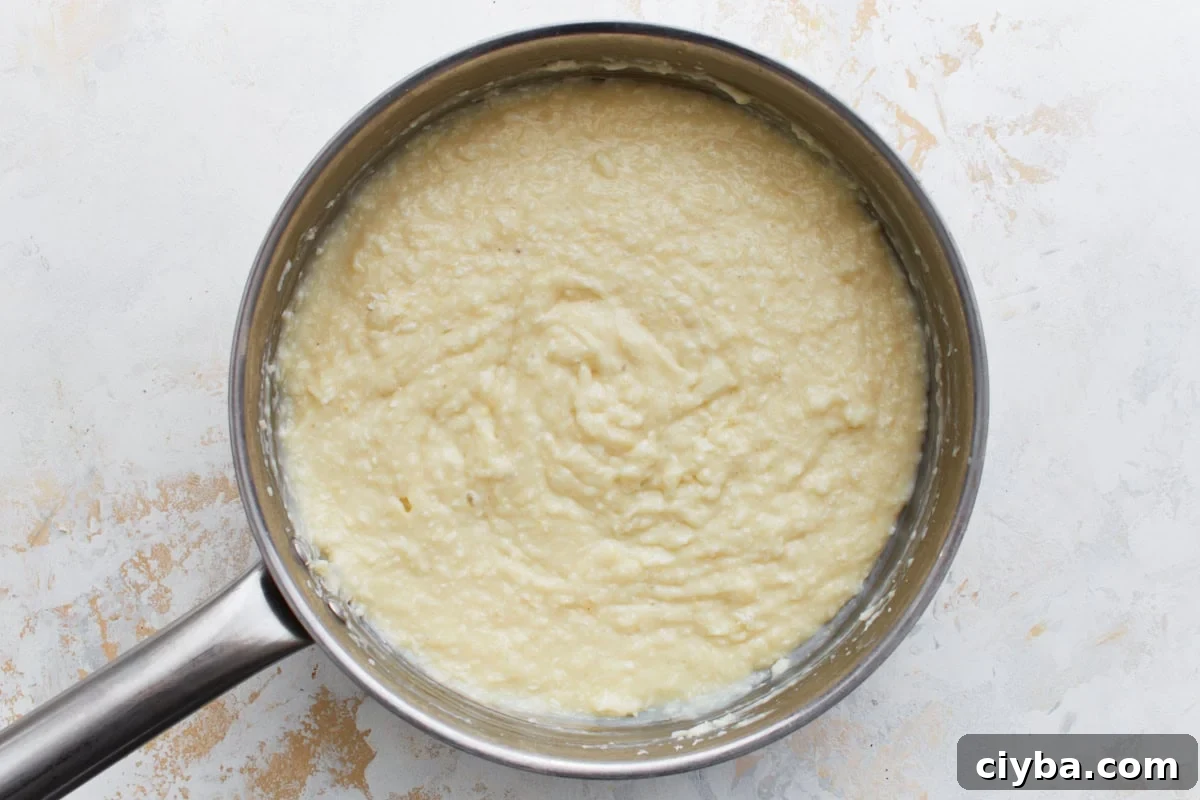 Finished thickened custard with coconut stirred in, ready to pour into crust.