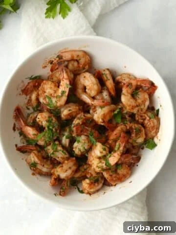 Blackstone cajun shrimp in a bowl with fresh parsley.