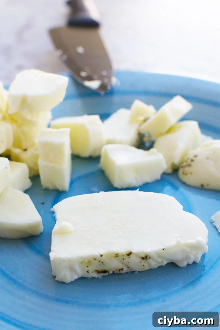 raw halloumi on a blue plate ready to be cooked