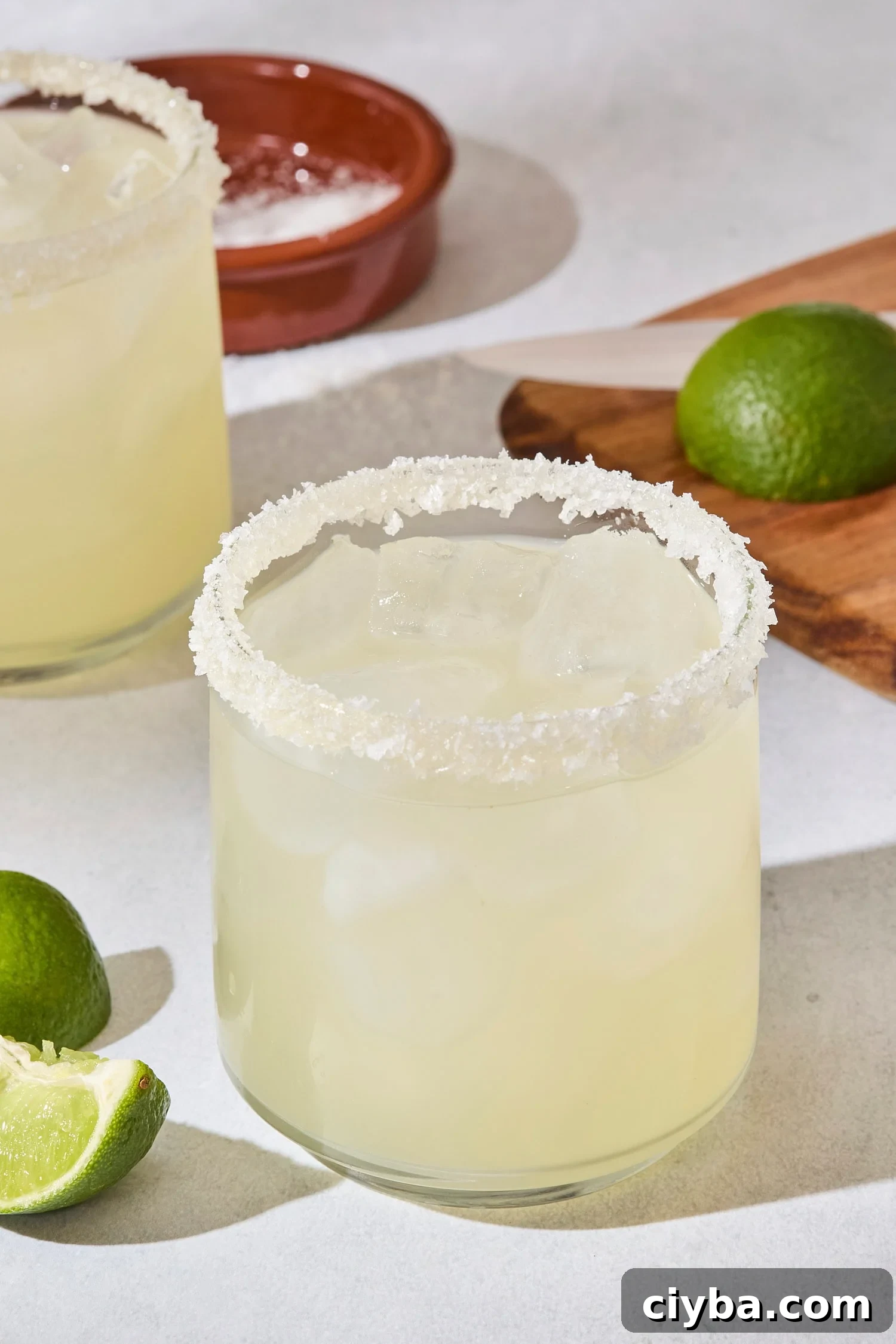 Classic Margarita Recipe: How to Make an Authentic Margarita 6 Glass filled with a lime margarita with salt rim on glass.