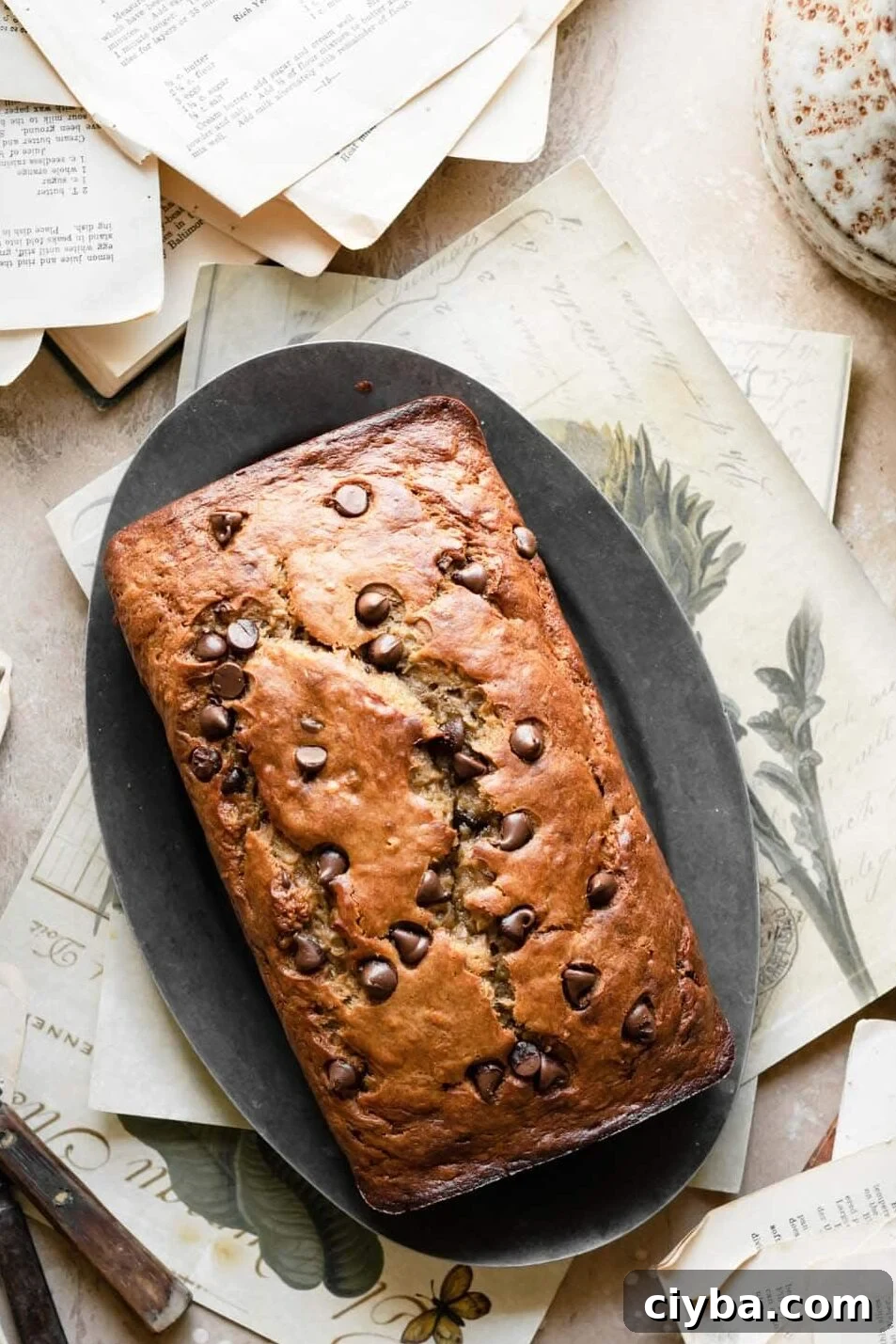 Loaf of banana bread on recipe cards.