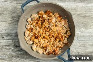 Chicken Nachos Recipe with Fresh Salsa and Avocado 9 This is a picture of a skillet with the ground chicken cooking.
