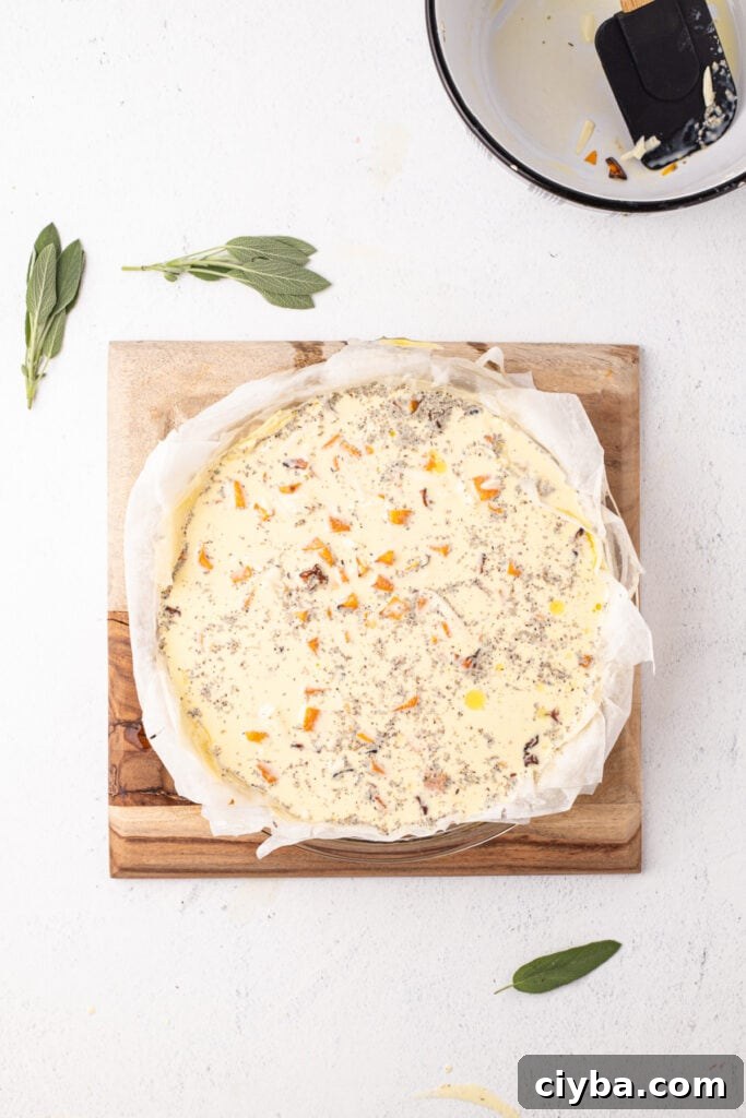 Prepared phyllo crust filled with uncooked quiche mixture of eggs, squash, cheese, cream, and herbs, ready for the oven.