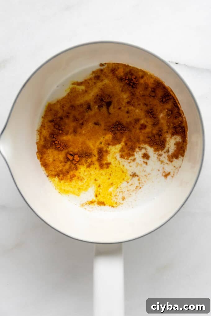 spices and almond milk in a white pot