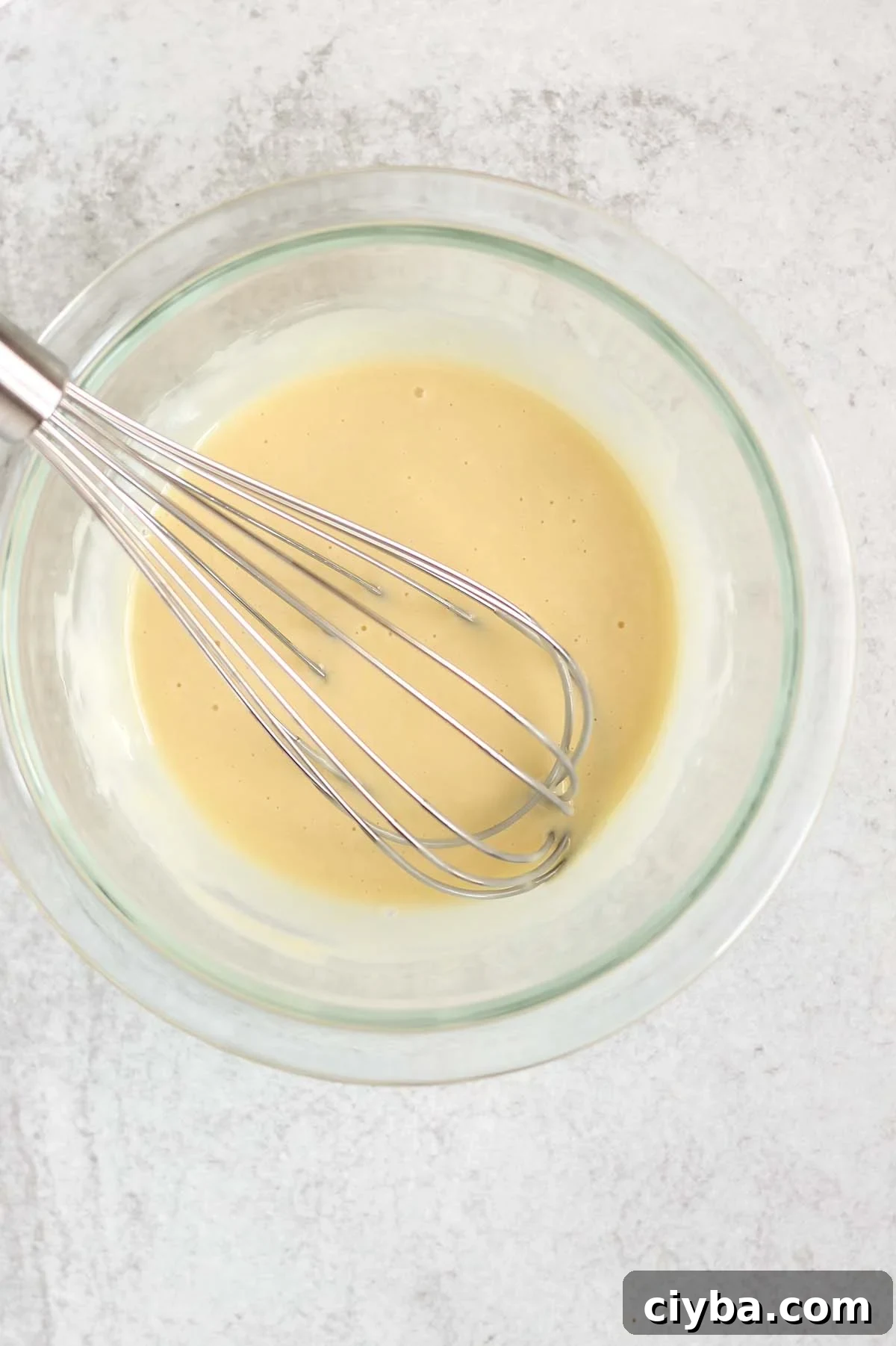 Creamy Whole30 and Paleo Coleslaw Recipe for BBQs and Meals 4 Coleslaw dressing being whisked in a mixing bowl.