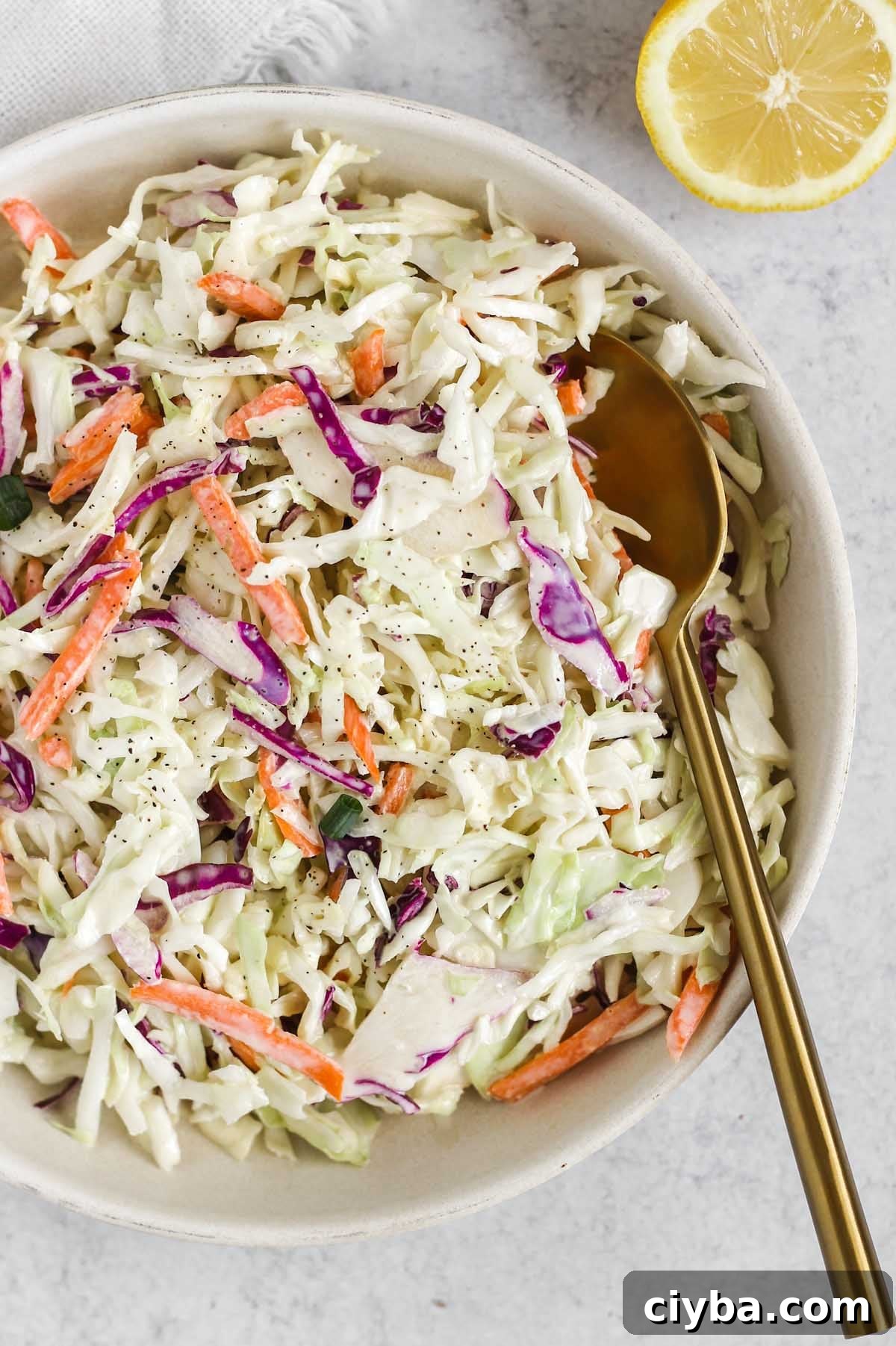 Creamy Whole30 and Paleo Coleslaw Recipe for BBQs and Meals 8 Close up of Whole30/Paleo coleslaw in a serving dish.