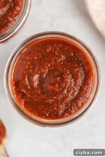 Overhead view of BBQ sauce in a mason jar.