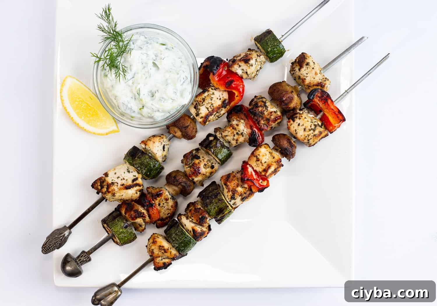 Grilled Lemon-Oregano Chicken Kabobs with a dipping sauce.