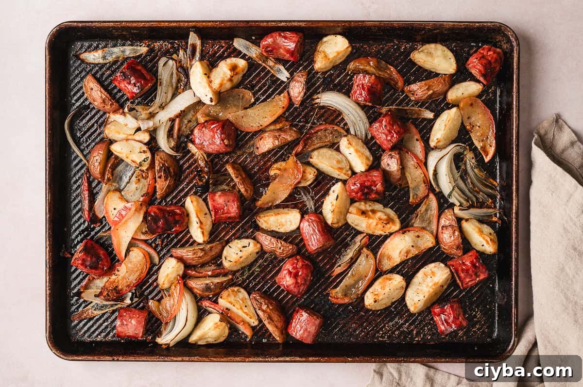 Overhead view of sheet pan potato, apple, and sausage