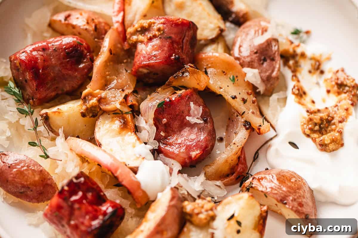 Close up of a plate of sheet pan potato, apple, and sausage