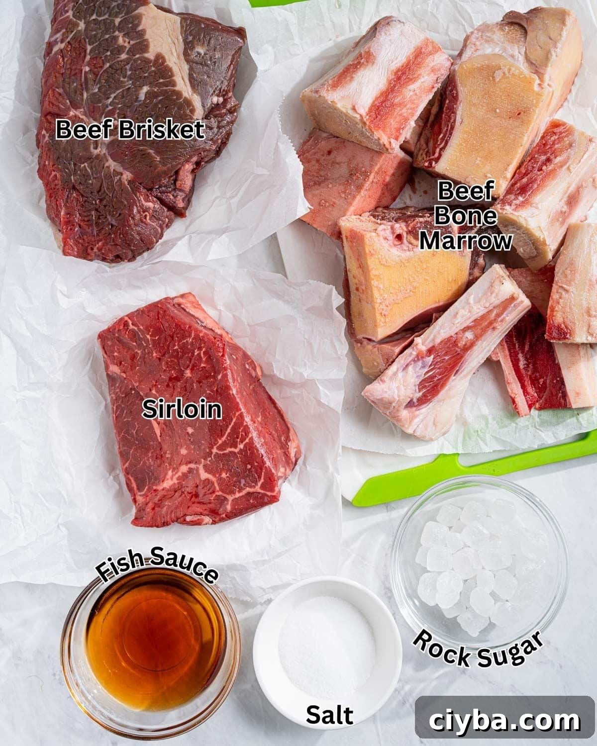 Beef bones and seasoning ingredients for pho tai broth: beef bone marrow, beef brisket, sirloin, fish sauce, salt, and rock sugar.