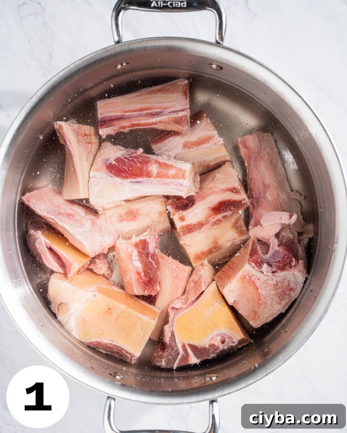 Boiling beef bones in a stockpot.