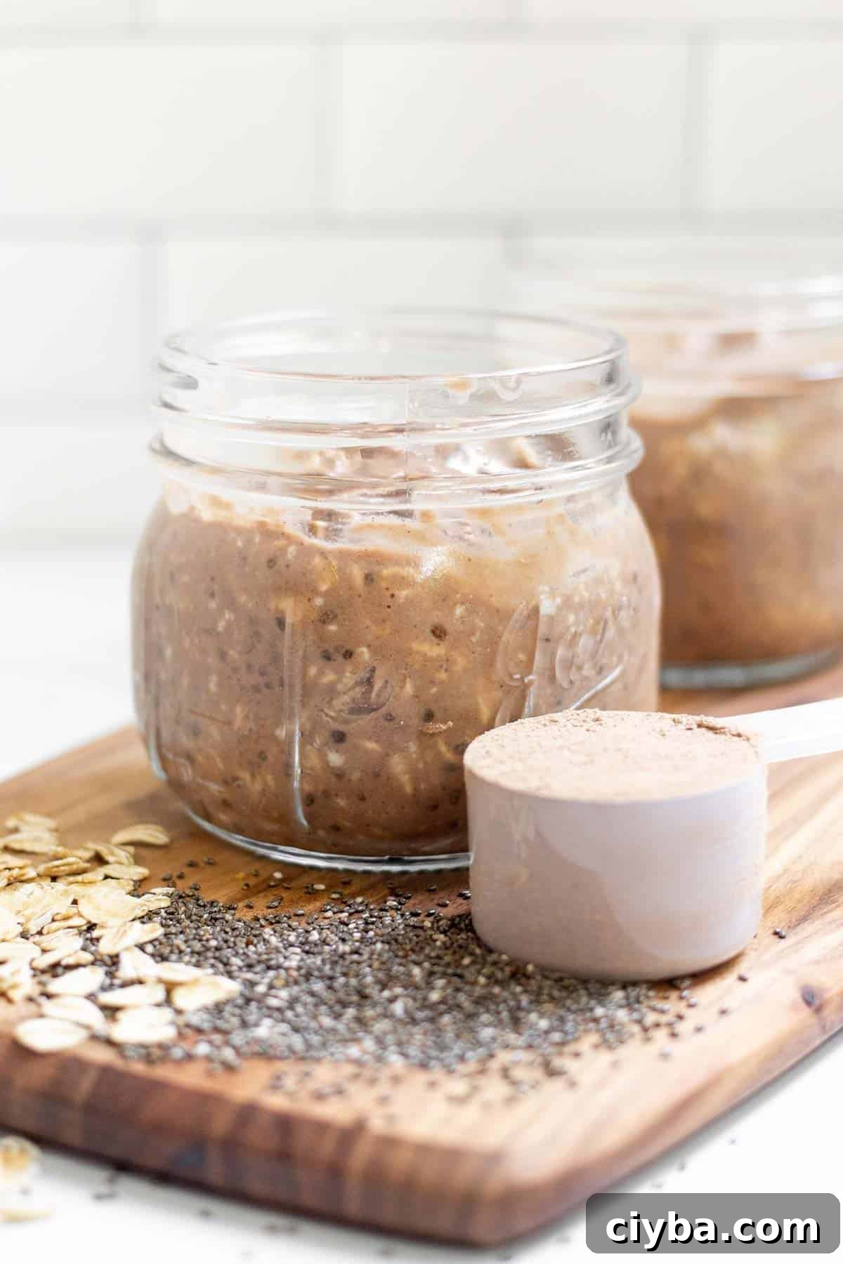 Side view of overnight oats in a 12 oz mason jar filled to the top.