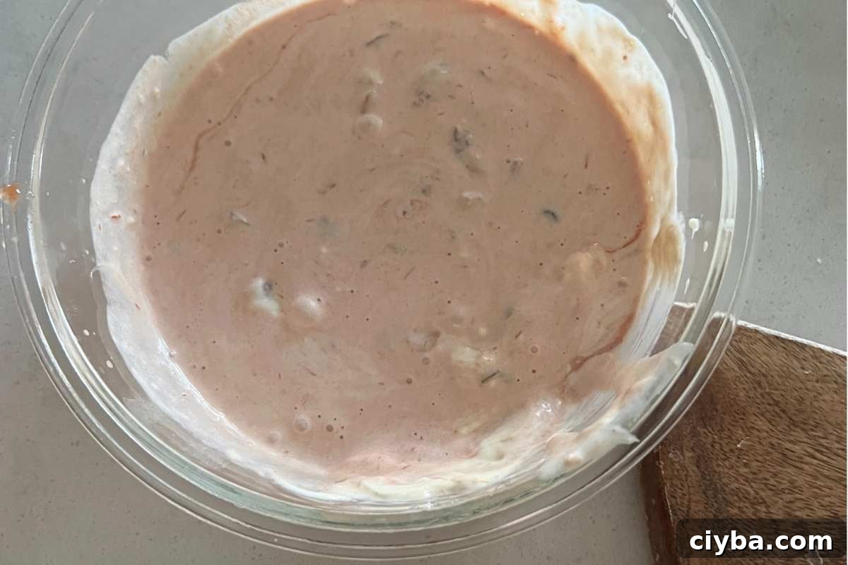 Dressing ingredients for macaroni salad mixed in a bowl. 