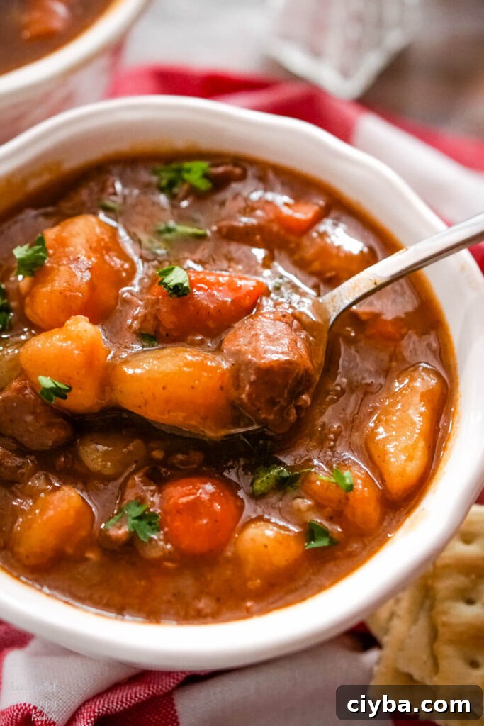 A white bowl full of instant pot beef stew. 