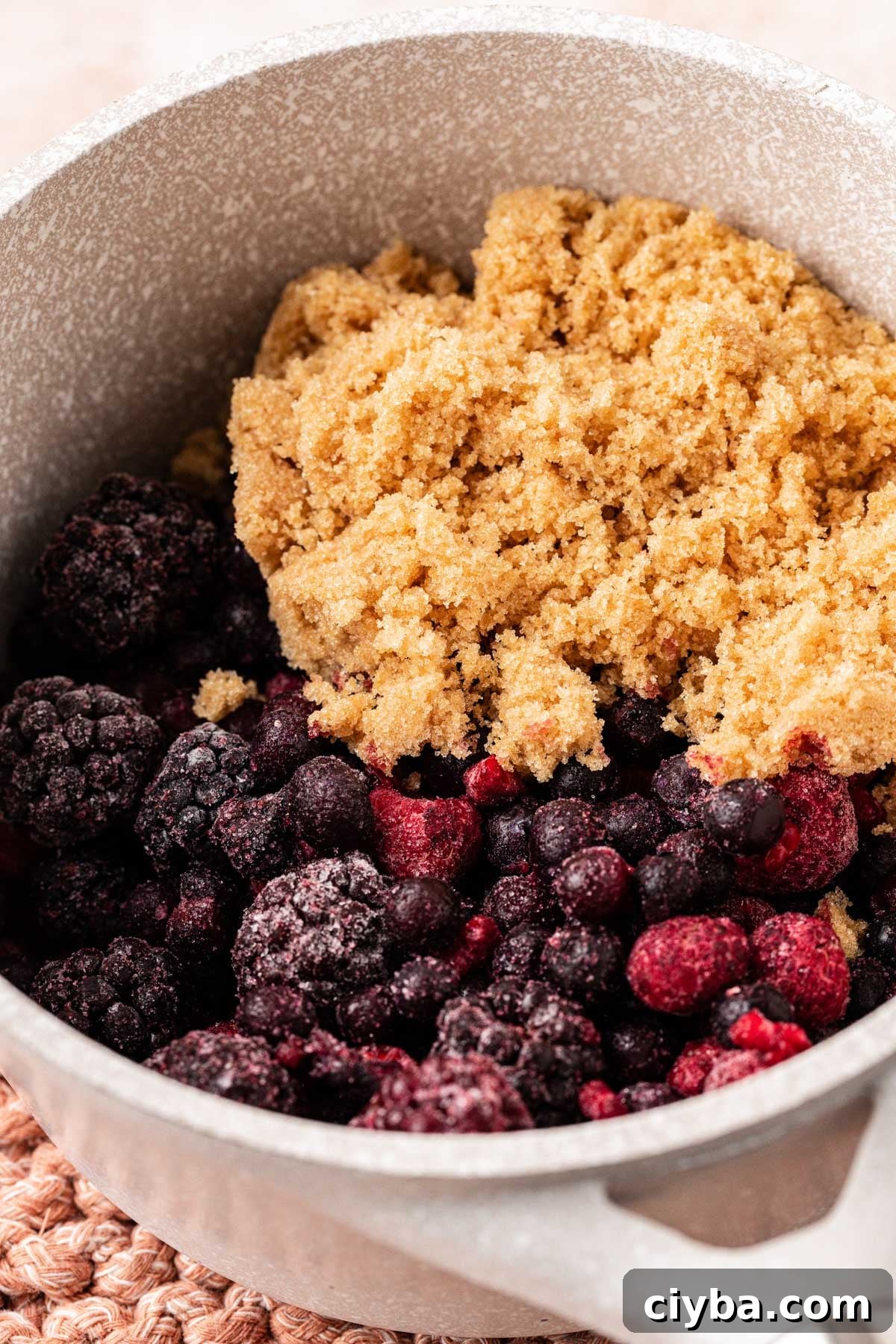 Ingredients for mixed berry compote in a pot ready to cook.