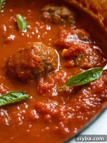 Sunday sauce with meatballs and sausage in a pot.