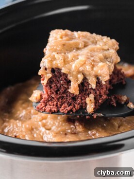 Slow Cooker German Chocolate Cake Recipe: Moist, Rich & Effortless 11 A spatula with a slice of German chocolate cake taken out of a slow cooker.