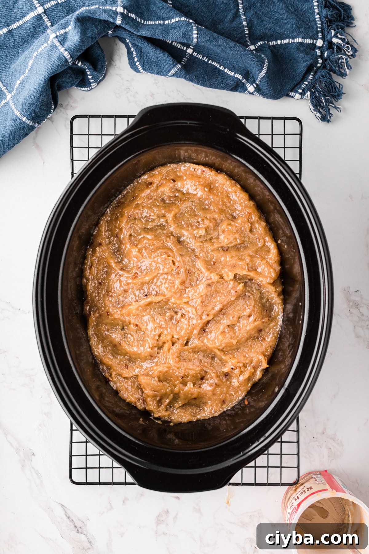 Slow Cooker German Chocolate Cake Recipe: Moist, Rich & Effortless 7 Slow cooker German chocolate cake with frosting in a crockpot.