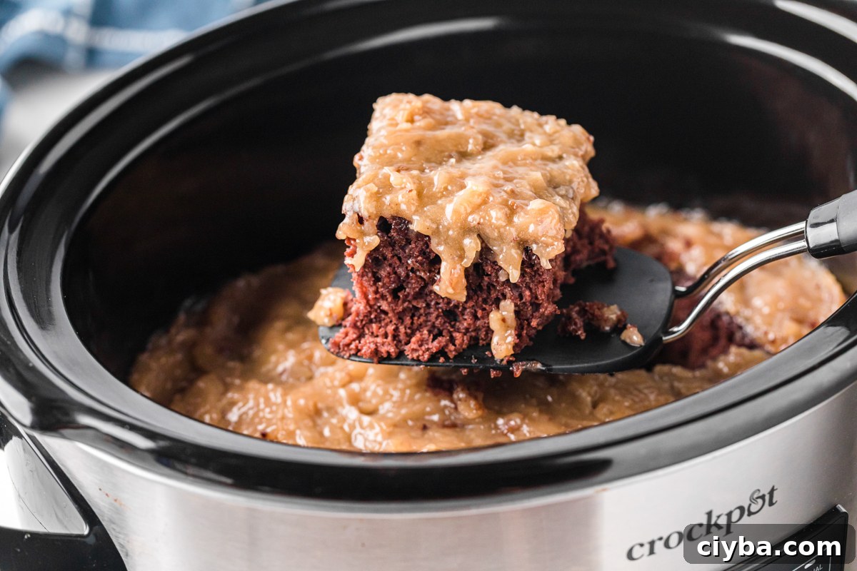 Slow Cooker German Chocolate Cake Recipe: Moist, Rich & Effortless 8 A spatula with a slice of German chocolate cake taken out of a slow cooker.