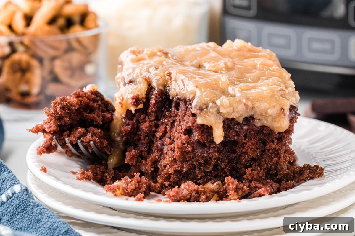 Slow Cooker German Chocolate Cake Recipe: Moist, Rich & Effortless 10 A slice of slow cooker German chocolate cake with a forkful taken out.