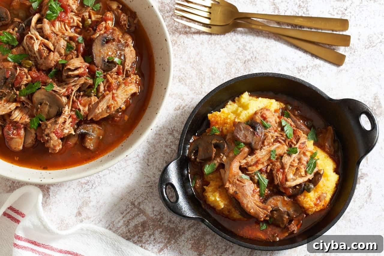 A large serving bowl and a cast iron serving dish of slow cooker chicken cacciatore. Three gold forks are in the upper right, a red and white striped towel is in the lower left.