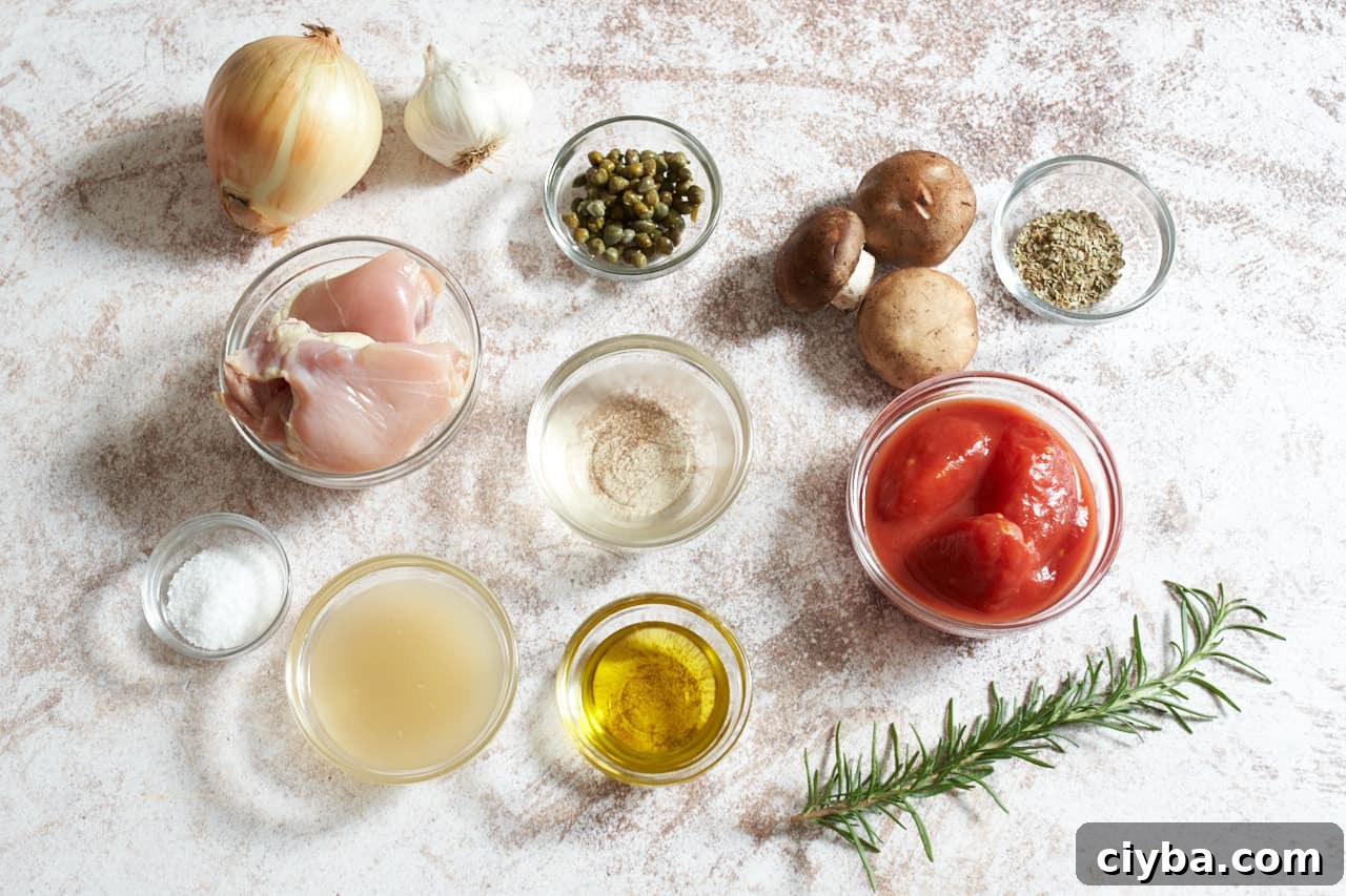 An onion, a garlic bulb, mushrooms, a sprig of rosemary, and small glass bowls of canned tomatoes, chicken broth, olive oil, capers, spices, and white wine.