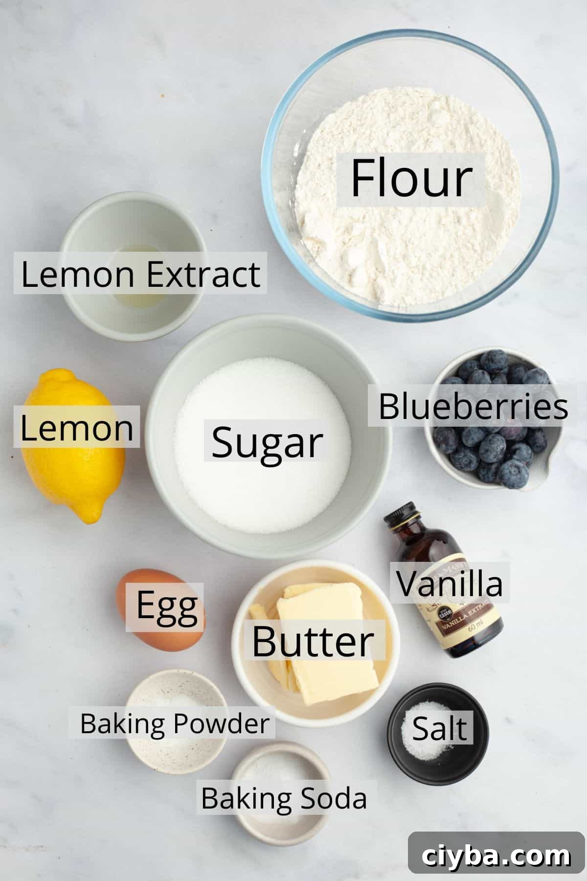 All the ingredients needed to make lemon blueberry cookies weighed out into small bowls.